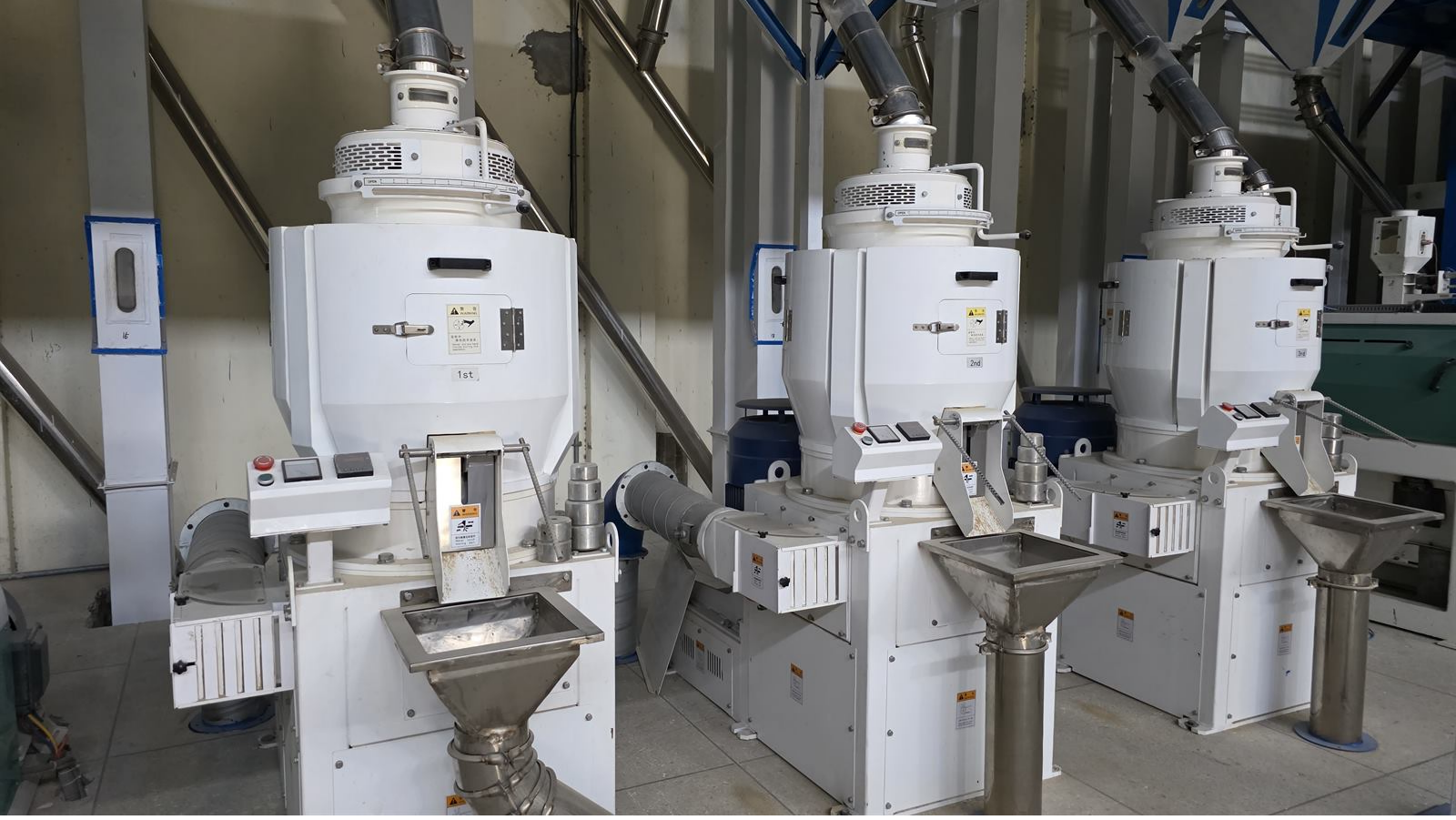 Rice whitener machinery in the finishing area.